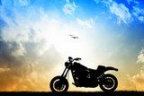 Zwoele zonsondergang met silhouet van motorfiets